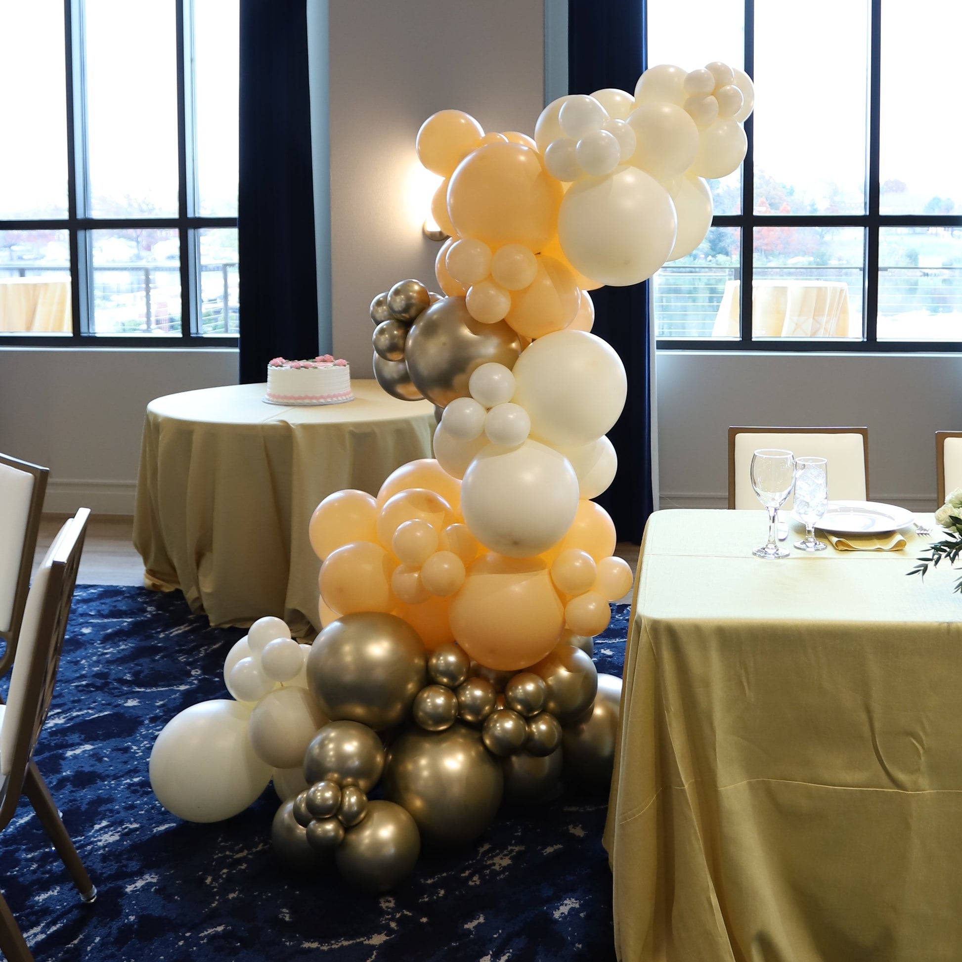 free standing balloon garland on base in blush, ivory, and gold
